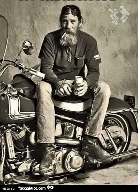 Vecchio biker fuma e beve birra sulla sua moto